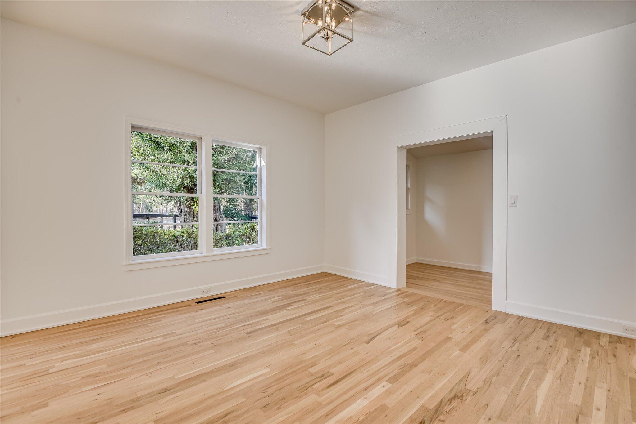 126 Mosley Road Aiken, SC 29801 - Photo 8 of 29 an empty room with wooden floor and windows