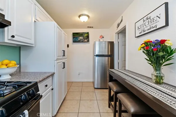 a kitchen with stainless steel appliances a refrigerator a stove a sink and cabinets