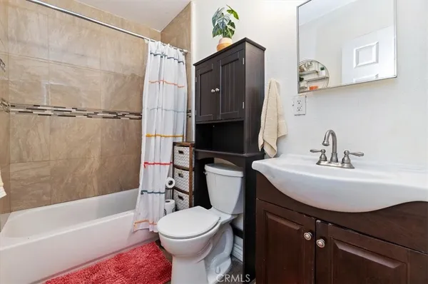 a bathroom with a sink a toilet and bathtub