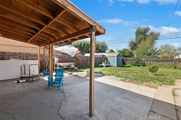 a view of a patio with a table and chairs