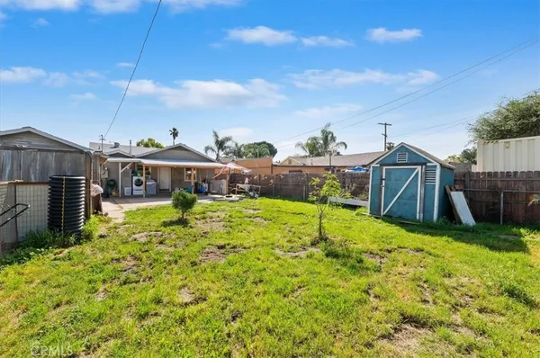 a view of house with backyard and deck