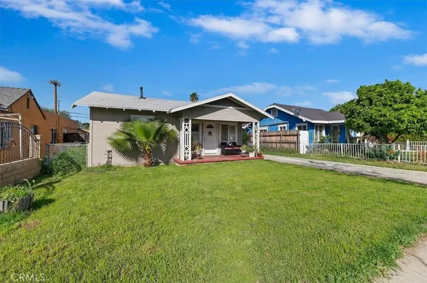 a front view of a house with yard and green space