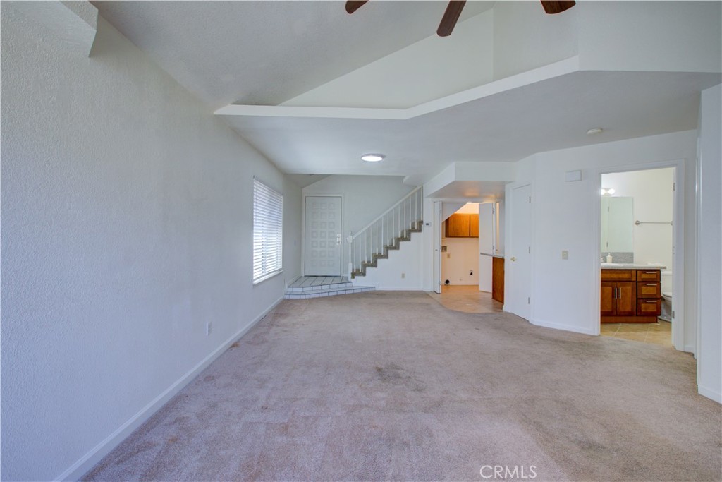 1247 Aspen Street Merced, CA 95340 - Photo 6 of 22 an empty room with wooden floor and white walls