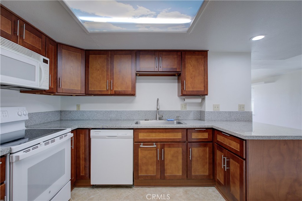1247 Aspen Street Merced, CA 95340 - Photo 7 of 22 a kitchen with stainless steel appliances granite countertop a sink stove and cabinets