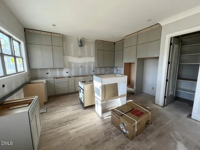 a open kitchen with cabinets microwave and refrigerator