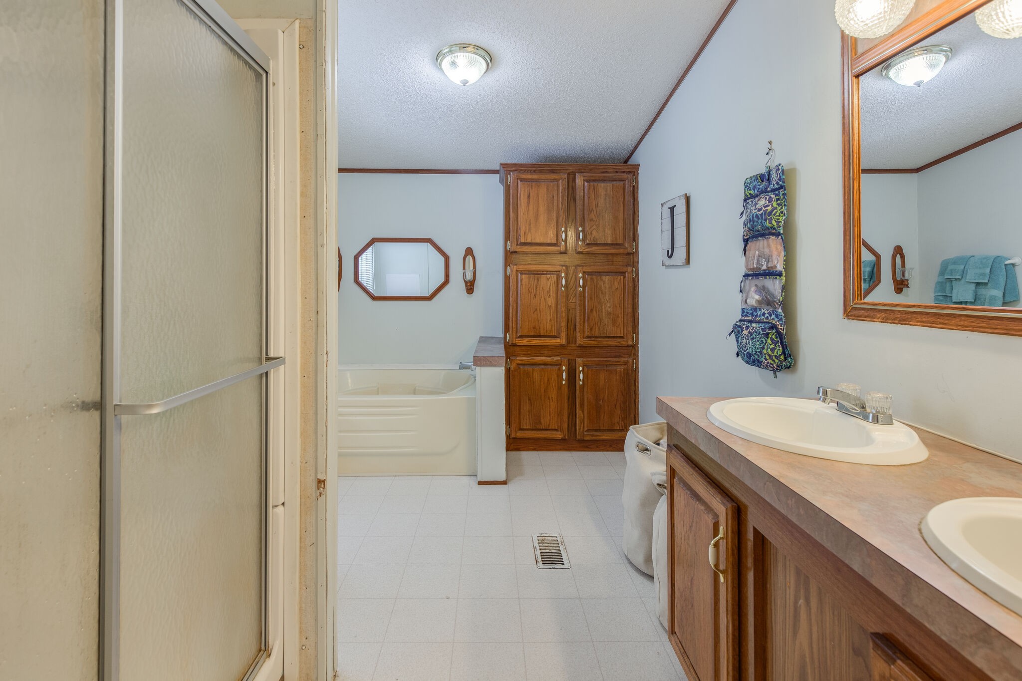 1054 Caps Ridge Dickson, TN 37055 - Photo 12 of 23 a bathroom with a sink a mirror and a shower