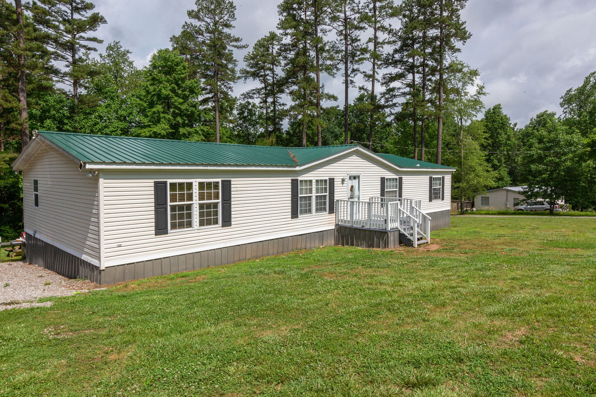 1054 Caps Ridge Dickson, TN 37055 - Photo 3 of 23 a view of a house with a small yard and a large tree