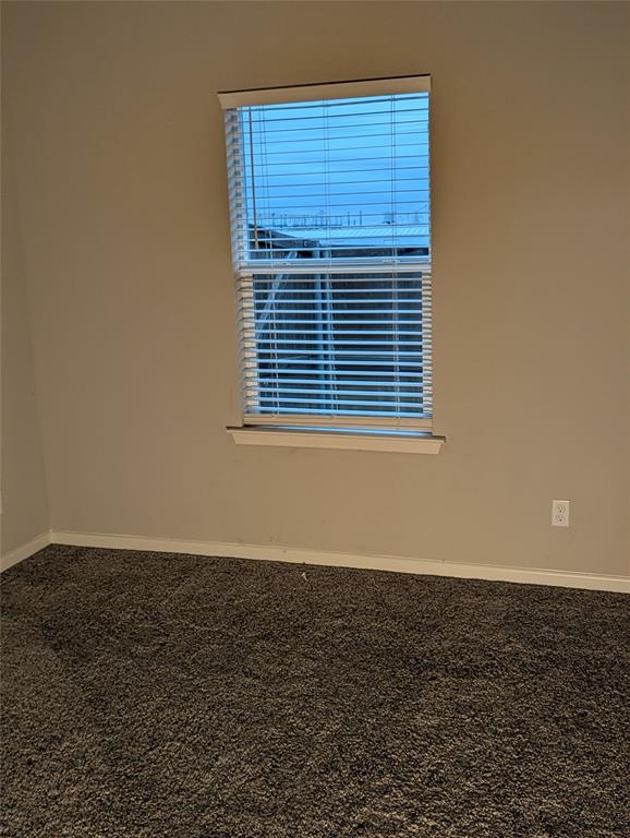 2700 Ginger Court Sherman, TX 75092 - Photo 13 of 22 a view of an empty room with wooden floor and a window