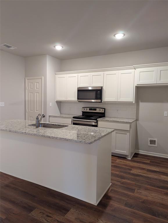 2700 Ginger Court Sherman, TX 75092 - Photo 2 of 22 a kitchen with appliances a sink and cabinets