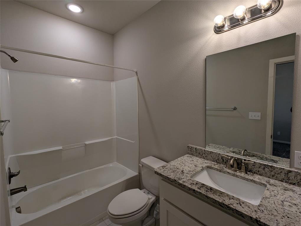 2700 Ginger Court Sherman, TX 75092 - Photo 21 of 22 a bathroom with a granite countertop sink toilet and shower