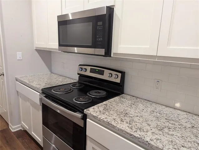 a kitchen with a stove and a microwave