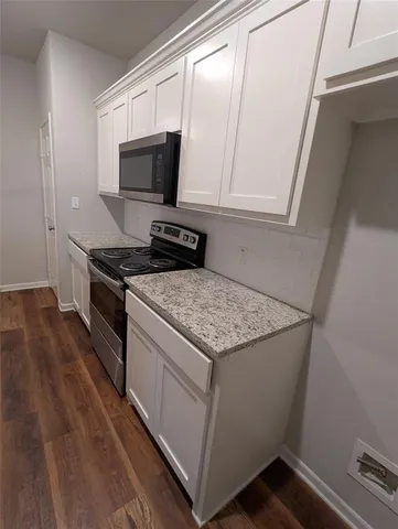a kitchen with a stove and a microwave