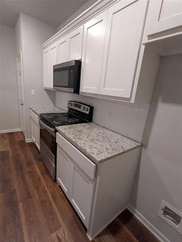 a stove top oven sitting inside of a kitchen