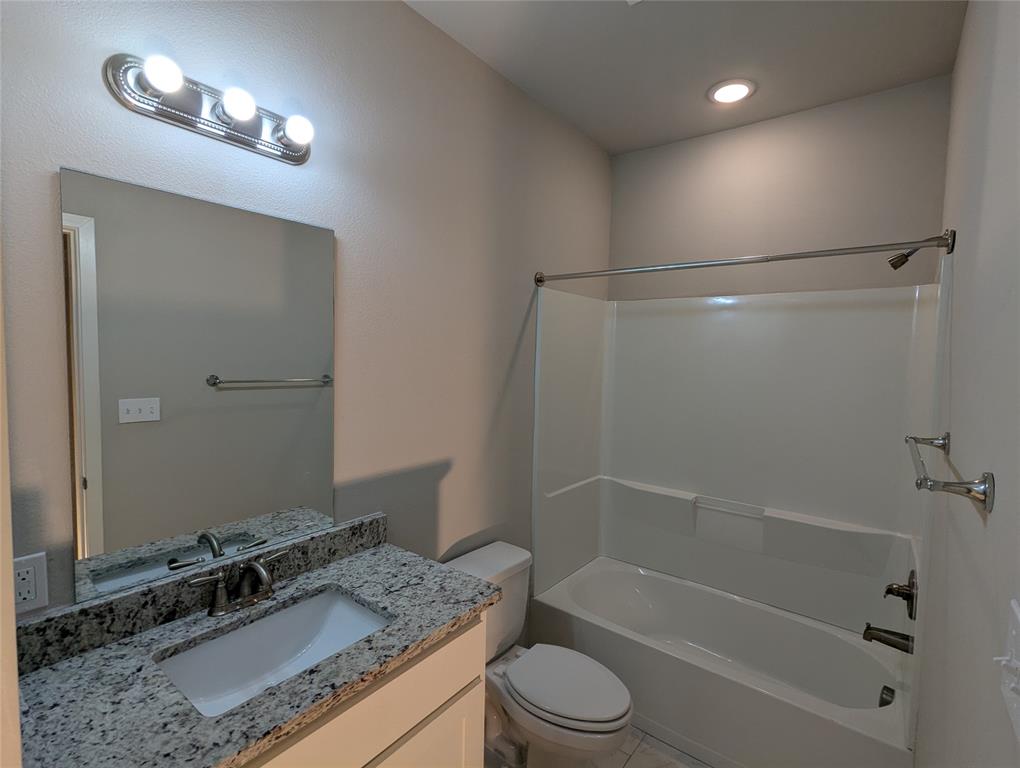 2700 Ginger Court Sherman, TX 75092 - Photo 8 of 22 a bathroom with a granite countertop sink a shower and a mirror