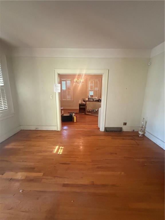 2808 Summerville Road Phenix City, AL 36867 - Photo 2 of 15 Spare room with a chandelier and wood finished floors