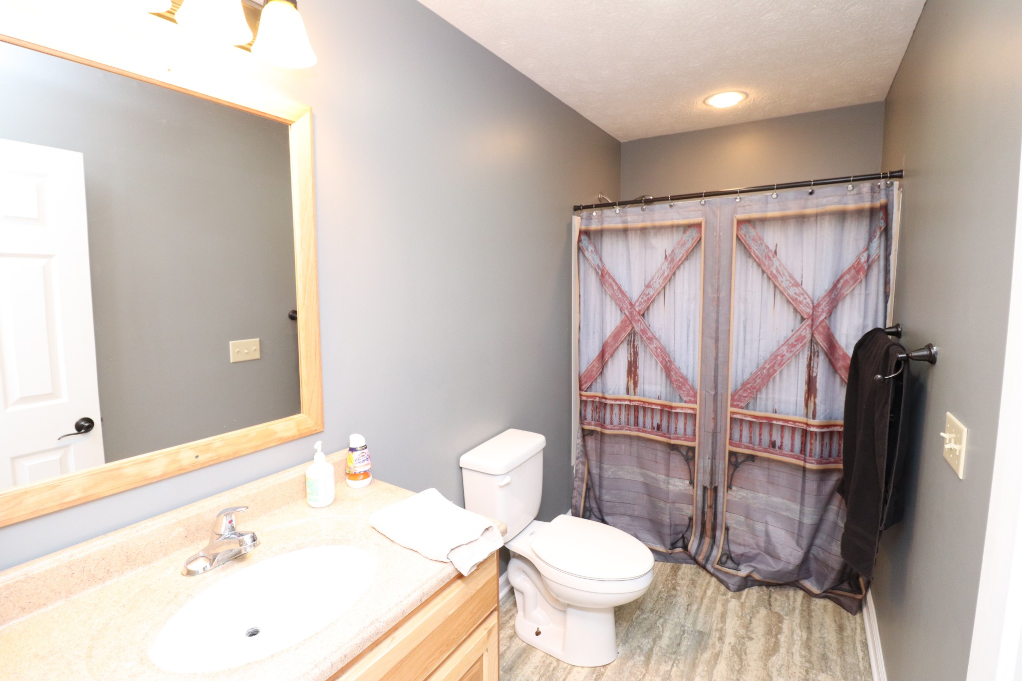 4753 Akersville Road Lafayette, TN 37083 - Photo 26 of 50 a bathroom with a sink a toilet and shower