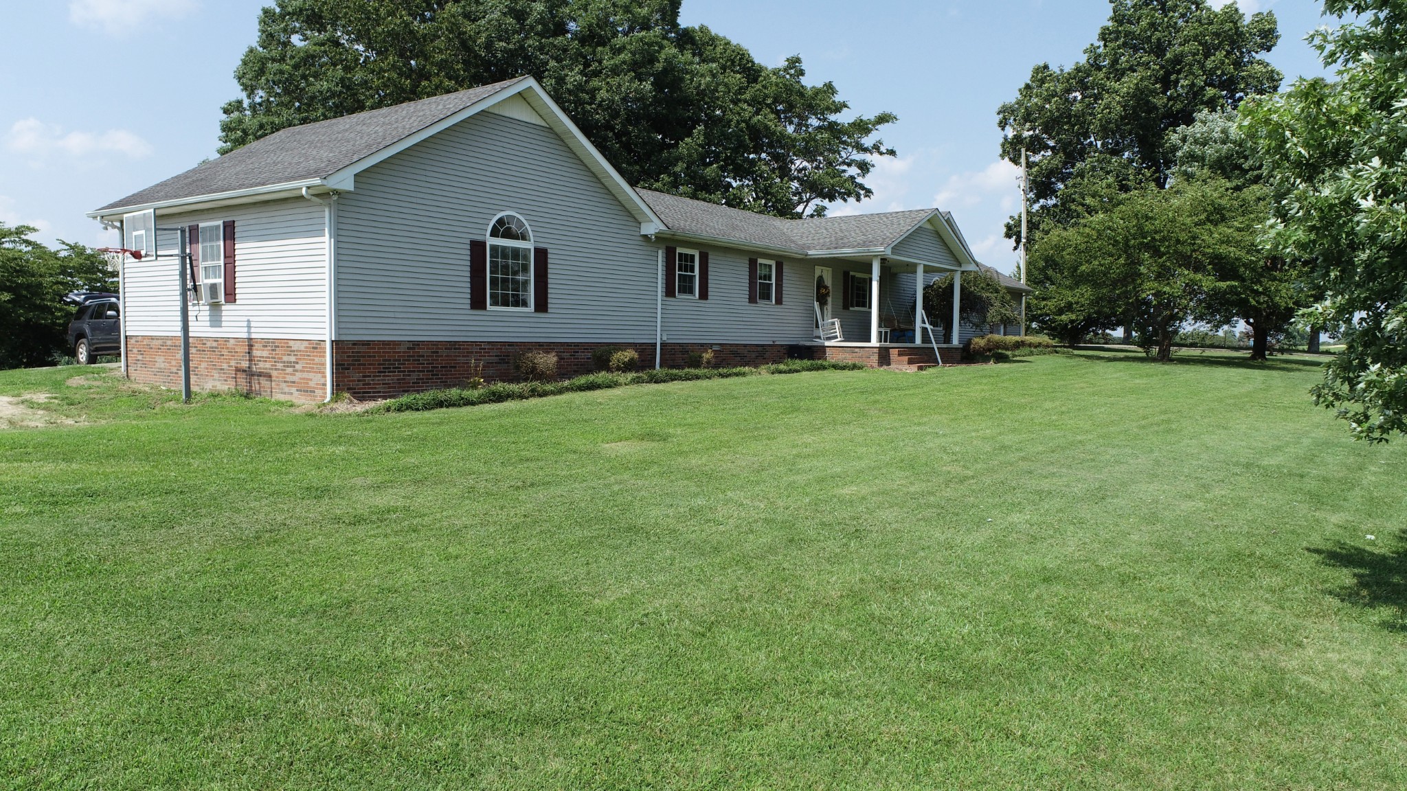 4753 Akersville Road Lafayette, TN 37083 - Photo 3 of 50 a front view of a house with a garden and trees