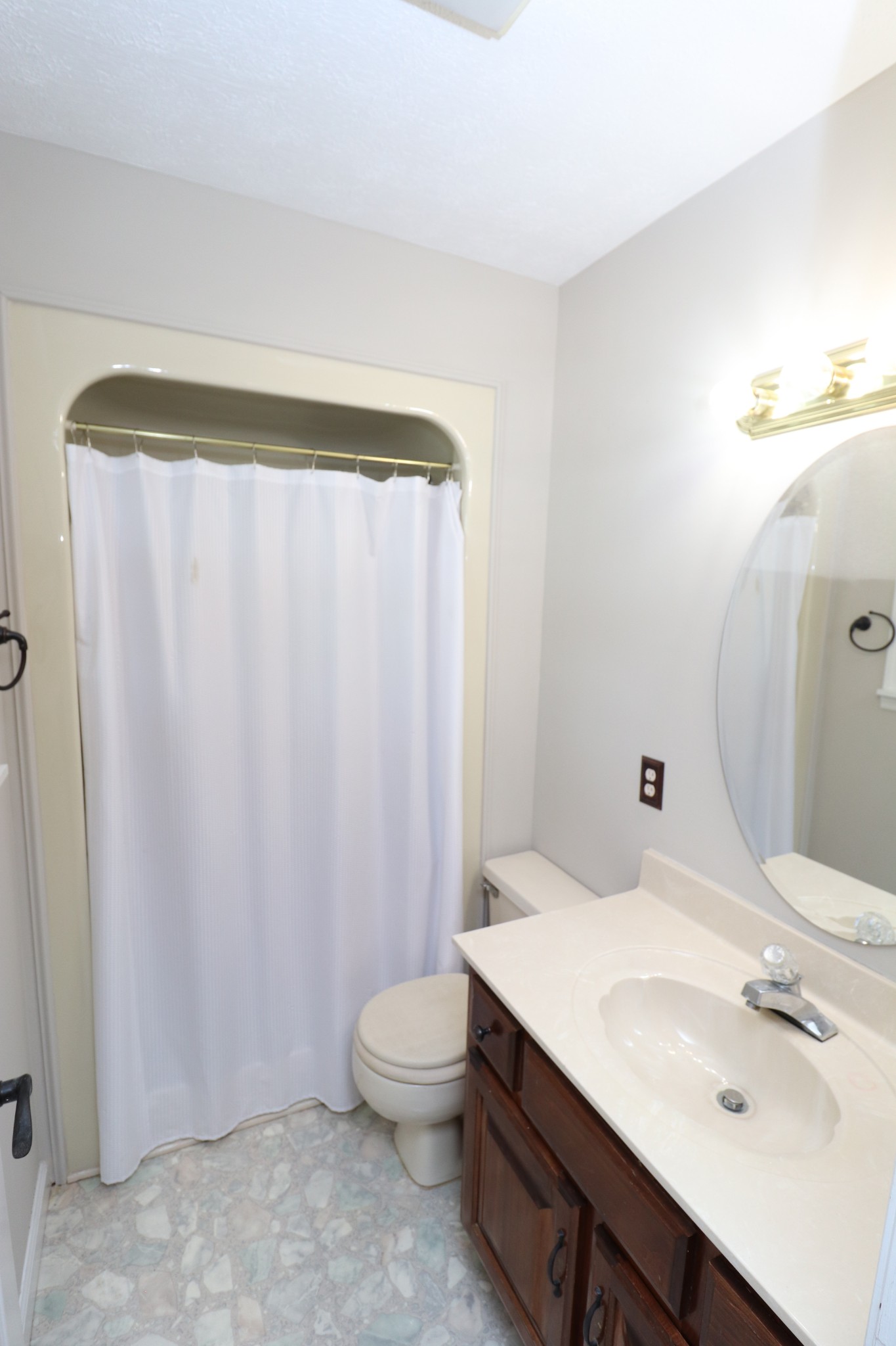 4753 Akersville Road Lafayette, TN 37083 - Photo 31 of 50 a bathroom with a sink a toilet and shower curtain