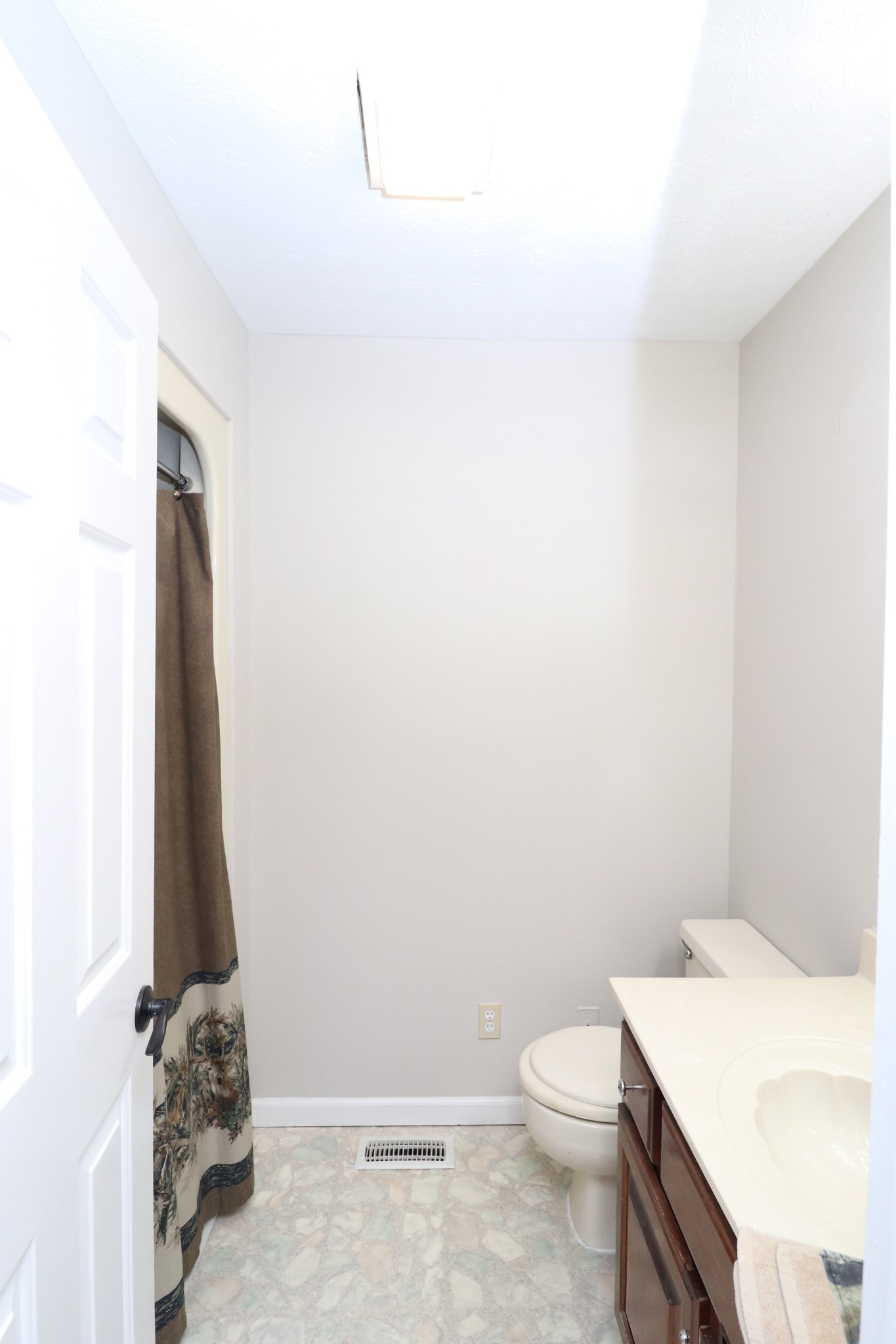 4753 Akersville Road Lafayette, TN 37083 - Photo 34 of 50 a bathroom with a sink a toilet and a vanity