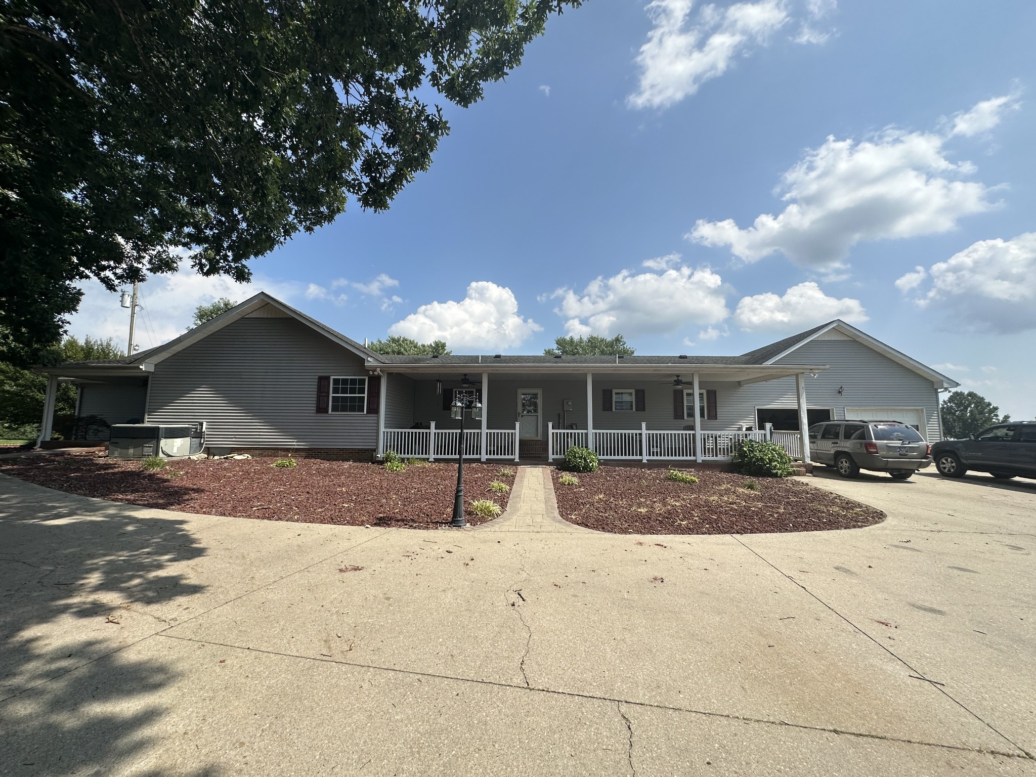 4753 Akersville Road Lafayette, TN 37083 - Photo 35 of 50 a front view of a house with a yard and garage