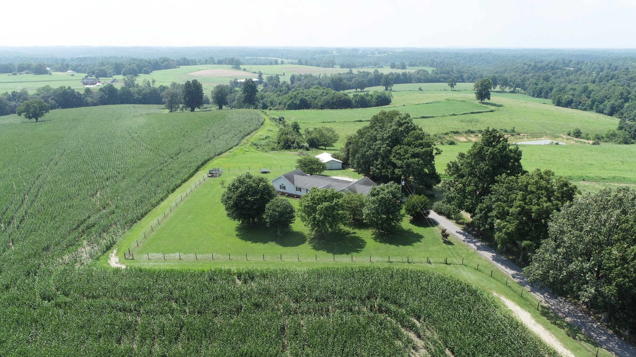 4753 Akersville Road Lafayette, TN 37083 - Photo 45 of 50 an aerial view of green landscape with trees houses and mountain view