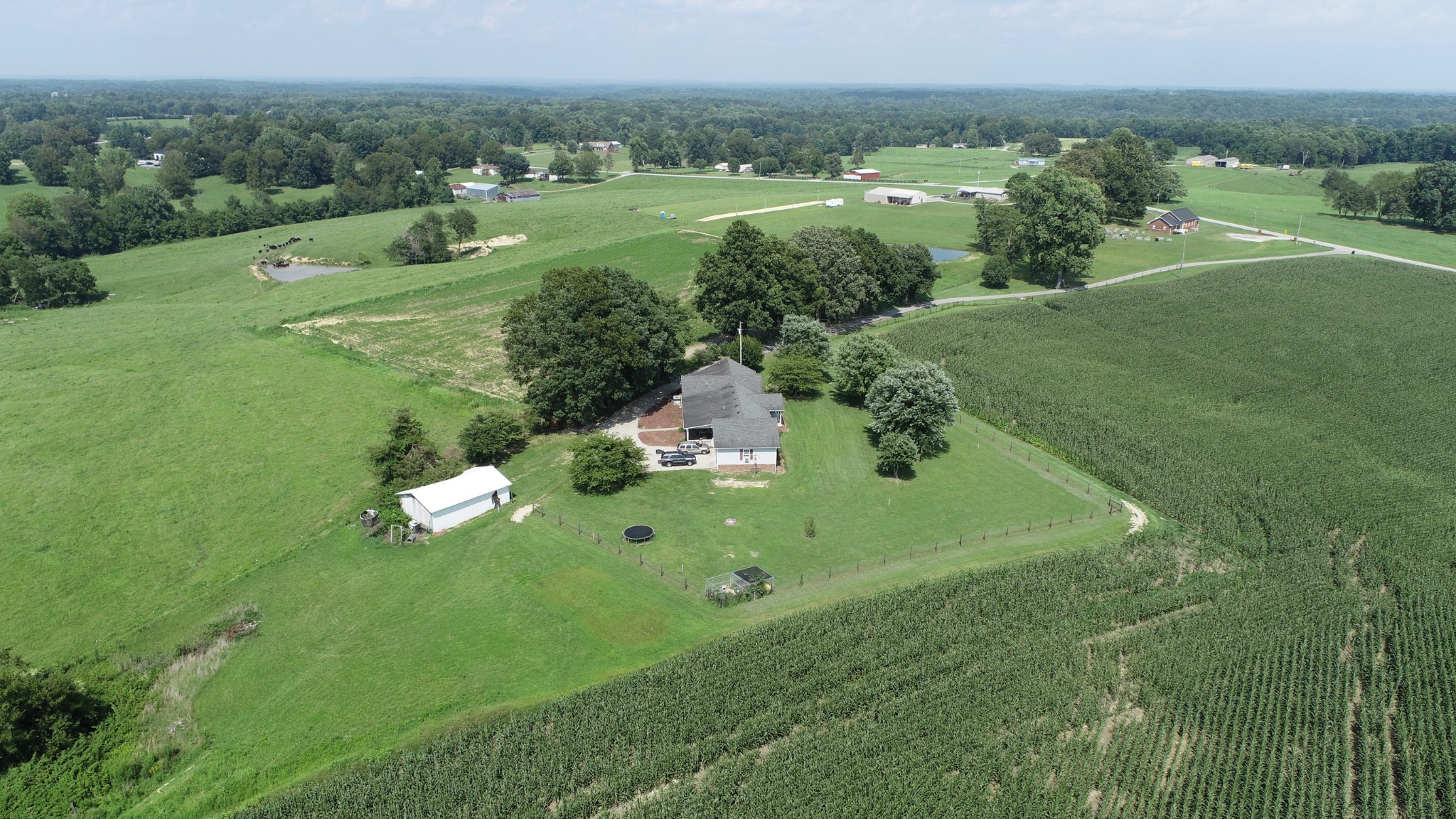4753 Akersville Road Lafayette, TN 37083 - Photo 47 of 50 an aerial view of green landscape with trees houses and mountain view