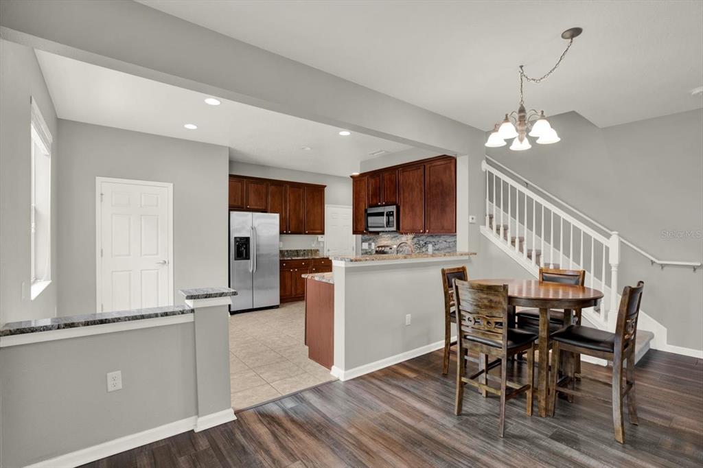 10228 Red Currant Court Riverview, FL 33578 - Photo 13 of 37 a view of a dining room with furniture a chandelier and wooden floor