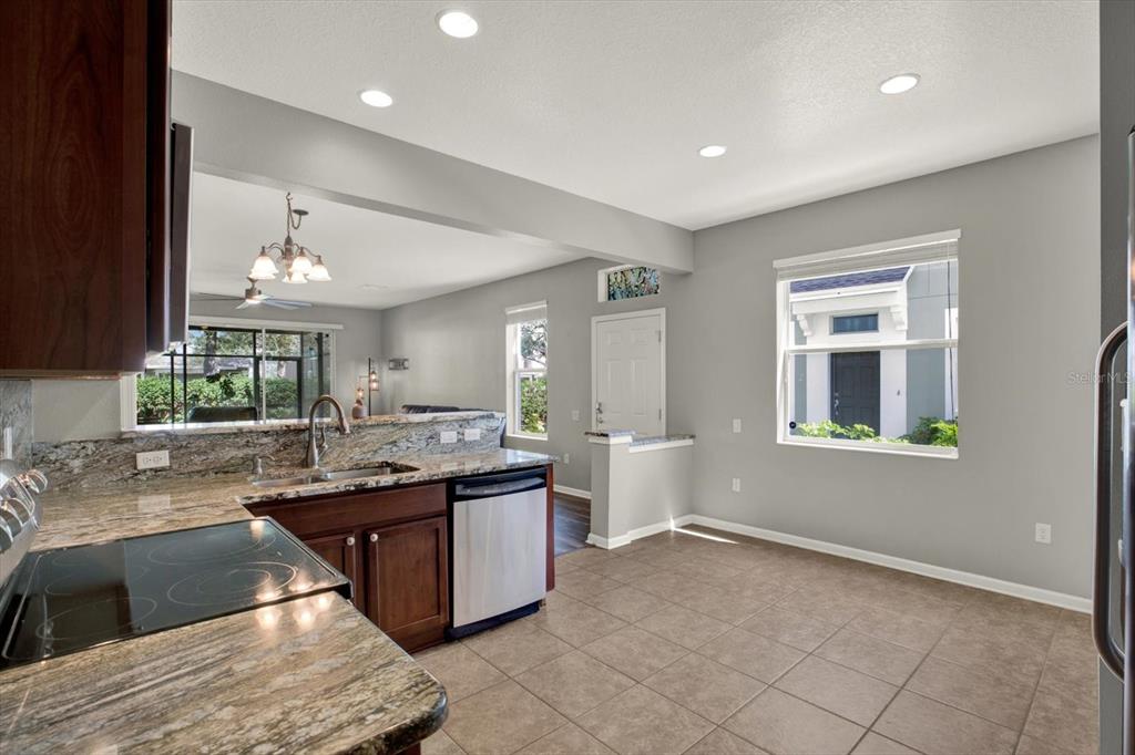 10228 Red Currant Court Riverview, FL 33578 - Photo 17 of 37 a large kitchen with kitchen island a sink stainless steel appliances and cabinets