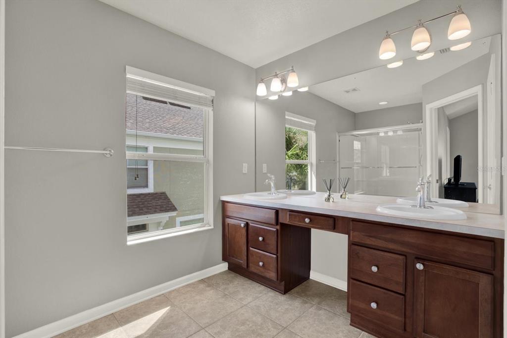 10228 Red Currant Court Riverview, FL 33578 - Photo 22 of 37 a spacious bathroom with a granite countertop sink a mirror and a vanity