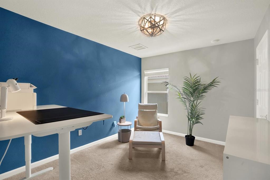 10228 Red Currant Court Riverview, FL 33578 - Photo 23 of 37 a living room with furniture and a potted plant