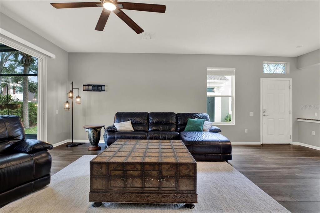 10228 Red Currant Court Riverview, FL 33578 - Photo 10 of 37 a living room with furniture and wooden floor