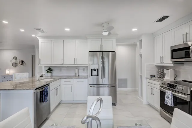 a kitchen with cabinets and window