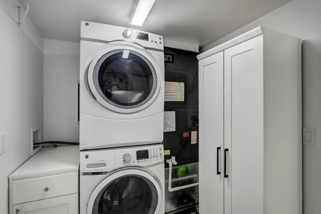 a bedroom with a white bed and a chandelier