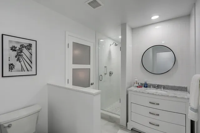 a bedroom with a bed and a painting on the wall