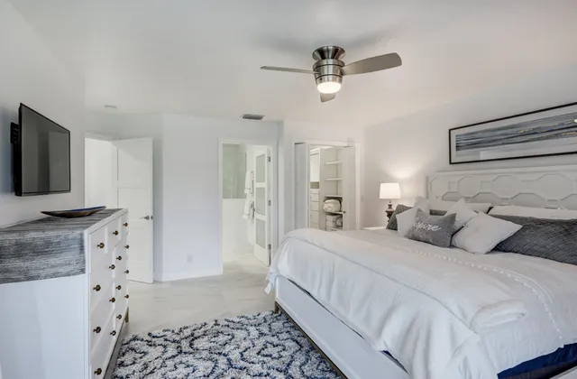 a bedroom with a bed and a flat screen tv