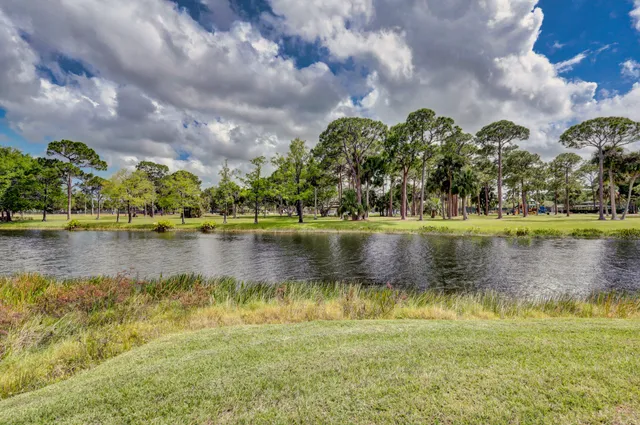 a view of a house with swimming pool and a yard