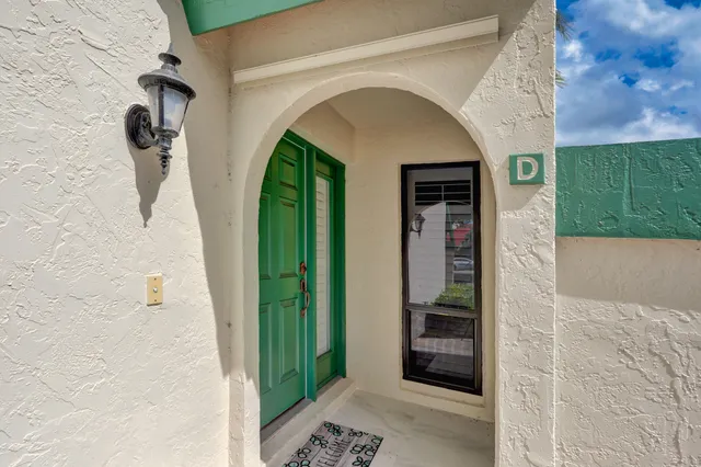 a living room with furniture and a large window with wooden floor