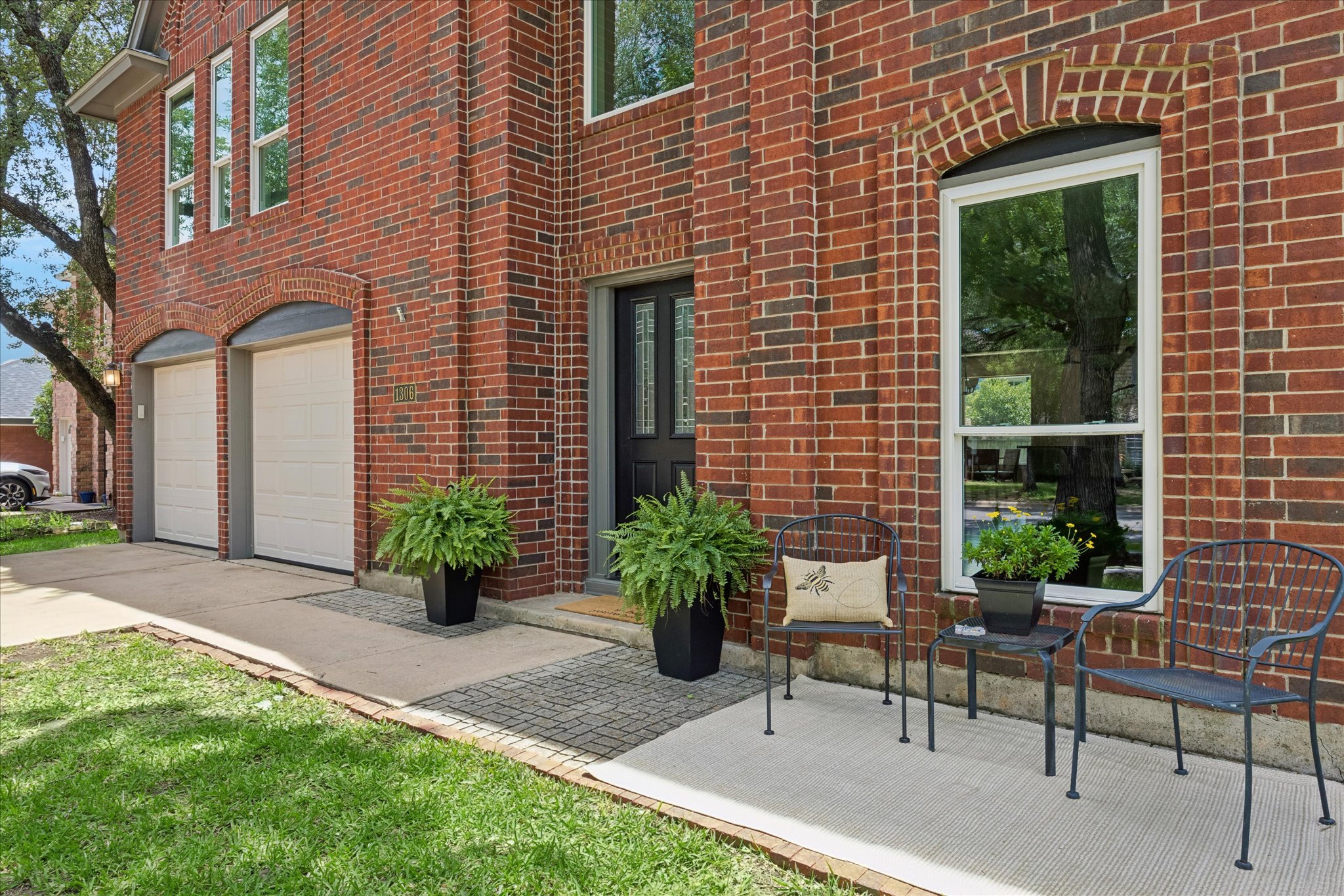 1306 Shady Grove Path Cedar Park, TX 78613 - Photo 2 of 40 a house view with a seating space and garden
