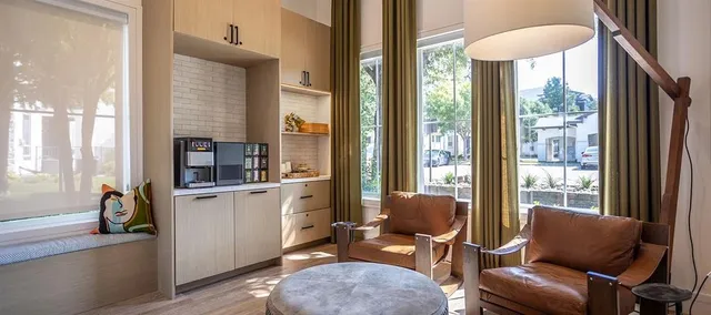 an aerial view of a house with swimming pool and large trees