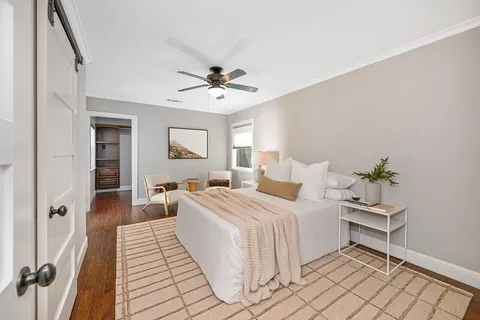 a bedroom with a large bed and a chandelier