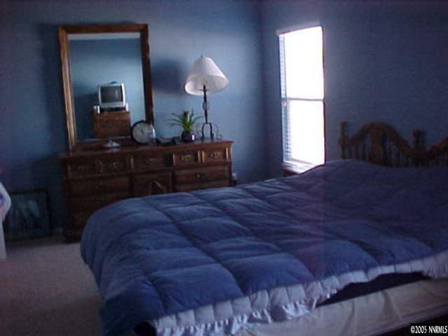7610 Bichon Street Reno, NV 89506 - Photo 4 of 4 a bedroom with a bed and a table lamp