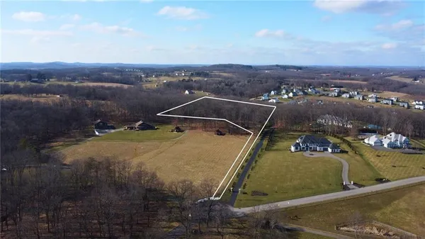 an aerial view of a house with a swimming pool