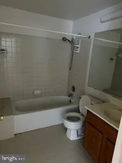 a white toilet sitting next to a bath tub and shower