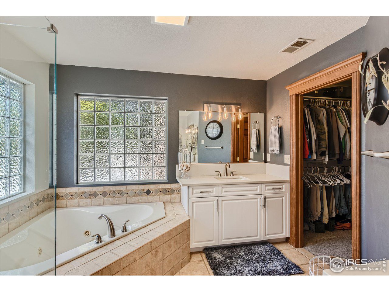 321 North Meldrum Street Fort Collins, CO 80521 - Photo 22 of 40 a bathroom with a tub sink and mirror