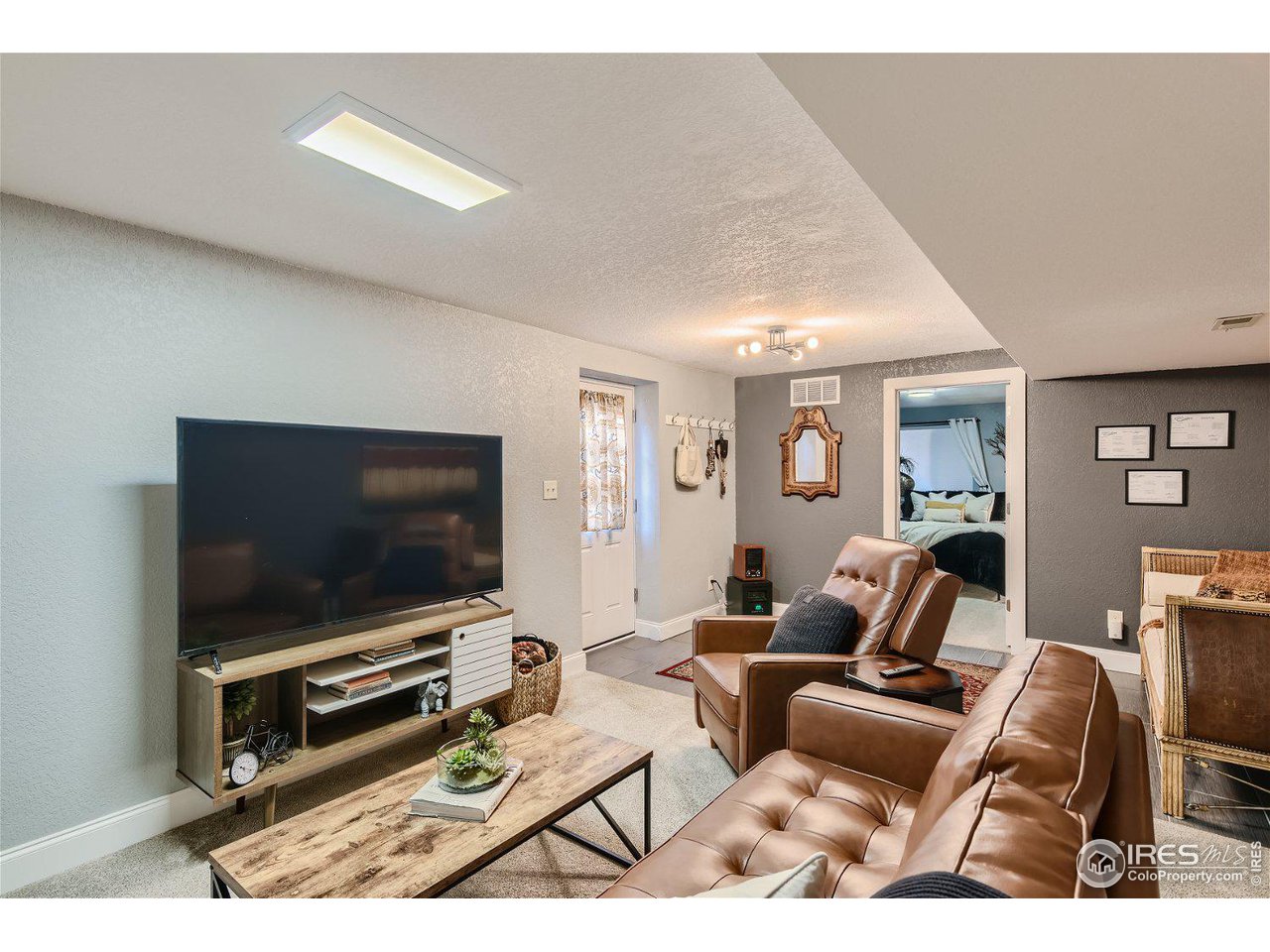 321 North Meldrum Street Fort Collins, CO 80521 - Photo 28 of 40 a living room with furniture and a flat screen tv