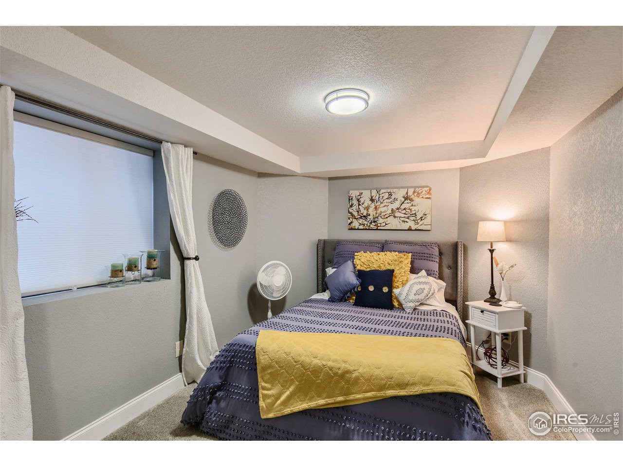 321 North Meldrum Street Fort Collins, CO 80521 - Photo 32 of 40 a bedroom with a bed and lamp