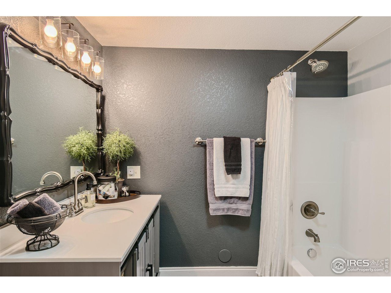 321 North Meldrum Street Fort Collins, CO 80521 - Photo 33 of 40 a bathroom with a sink and a mirror