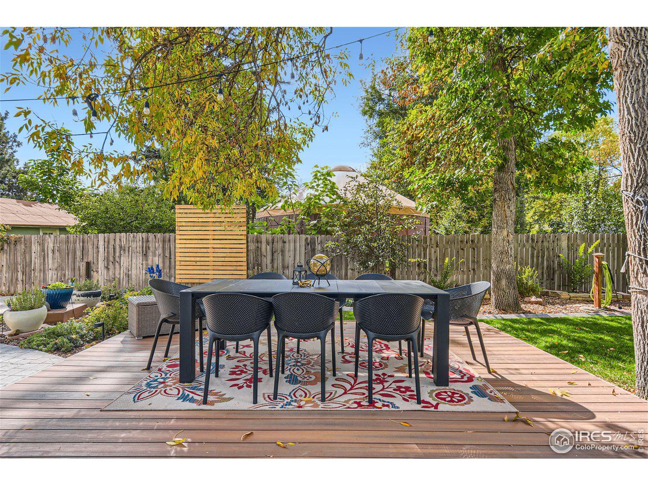 321 North Meldrum Street Fort Collins, CO 80521 - Photo 34 of 40 a view of a patio with table and chairs with wooden fence and plants