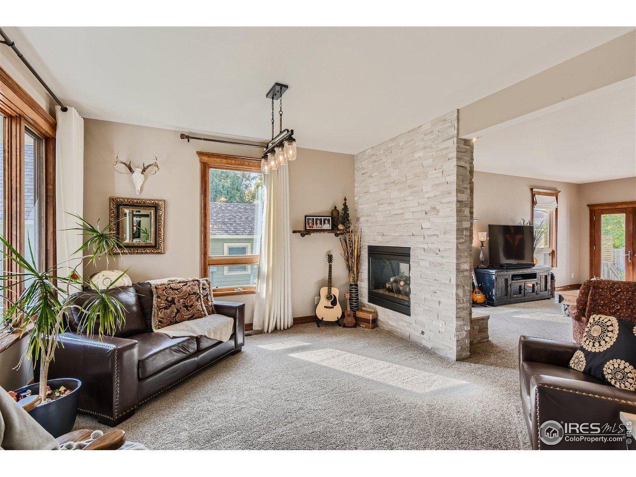 321 North Meldrum Street Fort Collins, CO 80521 - Photo 5 of 40 a living room with furniture and a fireplace
