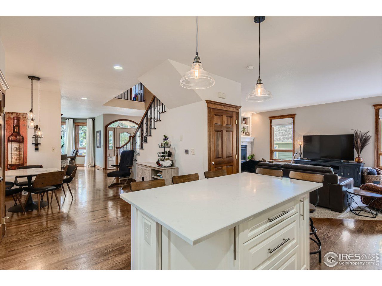321 North Meldrum Street Fort Collins, CO 80521 - Photo 9 of 40 a view of a dining room and livingroom with furniture wooden floor a chandelier